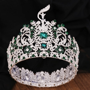 Detailed macro of Baroque silver crown with green gemstones and white diamond setting