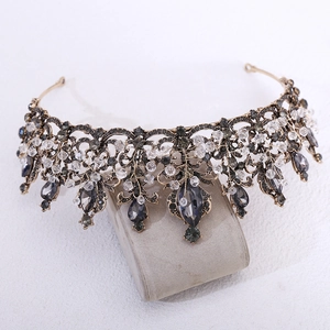 Close-up of vintage Baroque black crystal beaded crown with intricate bronze hollow design