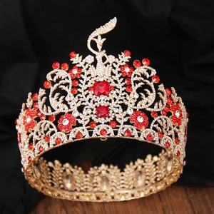 Luxurious gold Baroque pageant crown with red crystals and elegant phoenix details