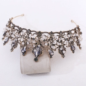 Vintage Baroque black crystal beaded crown on a gray velvet stand with bronze metal
