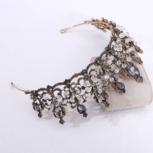 Detail of baroque black crystal bridal crown with vintage gold alloy and rhinestones