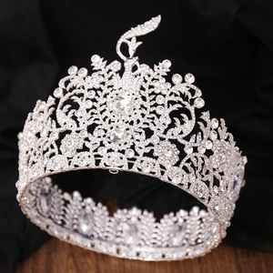 Detailed view of silver peacock crown with sparkling rhinestones on black velvet