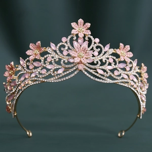 Détail de diadème de mariée doré avec cristaux roses et motifs floraux sur velours vert