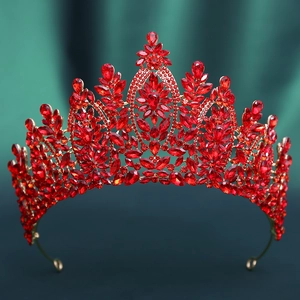 Macro shot of red crystals and golden leaves on a baroque bridal tiara crown