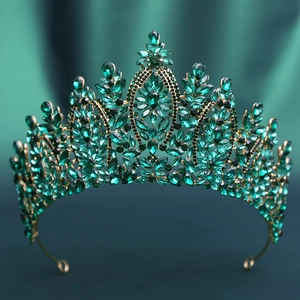 Detailed view of Baroque wedding crown with dark green crystals and golden alloy frame
