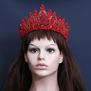 Vintage baroque golden bridal crown with luxury red crystals on mannequin head