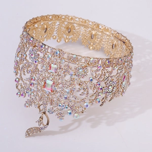 Macro shot of luxurious Baroque gold crown featuring AB rainbow crystals and peacock details