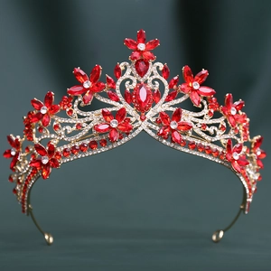 Detailed view of Baroque bridal crown with red crystals and gold floral rhinestone motifs