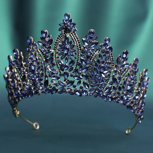 Detailed close-up of a golden bridal crown featuring elegant navy blue crystal inlays