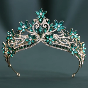 Close-up of baroque bridal crown with green crystals and floral rhinestone details