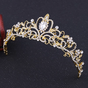 Close-up of golden bridal crown featuring white rhinestones and a large teardrop gem