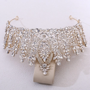 Detailed front view of baroque gold wedding tiara with crystal and rhinestone clusters