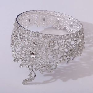 Macro shot of silver baroque crown showing intricate hollow patterns and crystal details