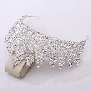 Close-up of baroque silver bridal crown with intricate crystal leaves and teardrop zircons