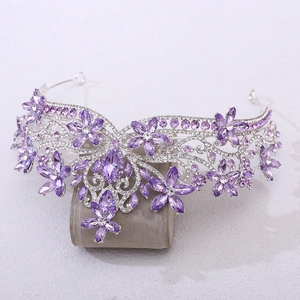 Close-up of silver bridal tiara with purple crystals and floral rhinestone patterns