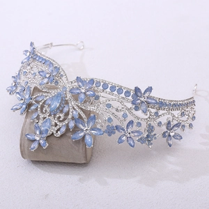 Detailed side view of baroque bridal crown with blue crystal flowers and white rhinestones