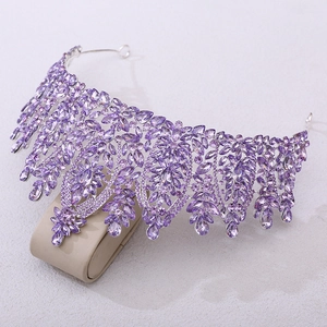 Macro shot of silver bridal crown featuring purple teardrop rhinestones on jewelry stand