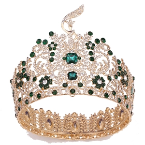 Macro detail of golden baroque pageant crown with emerald gemstones and intricate floral pattern