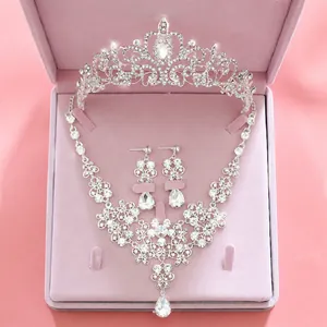Macro detail of bridal jewelry set with crystal tiara necklace and earrings in pink velvet box