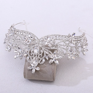 Close-up of silver bridal crown featuring floral rhinestone patterns and marquise crystals