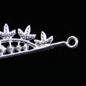 Macro detail of silver maple leaf bridal crown with textured alloy and pearls