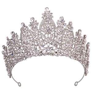 Close-up of ornate silver bridal crown with intricate floral crystals and end loops