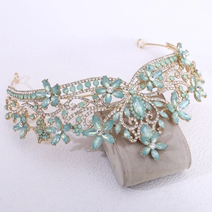 Detailed view of golden flower tiara with light blue crystals and micro-pave rhinestones