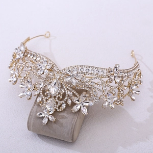 Detailed close-up of Baroque gold bridal tiara with floral crystal rhinestones