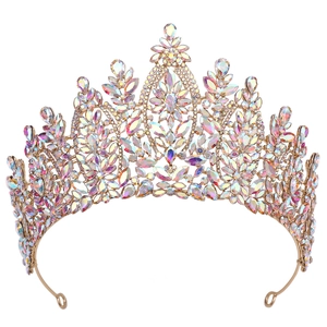 Close-up of golden baroque crown featuring intricate filigree and AB crystal rhinestones