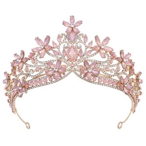 Macro shot of pink marquise crystals and flower-shaped rhinestones on a gold bridal crown