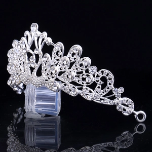 Elegant silver bridal crown with intricate crystal rhinestones and curved metal design