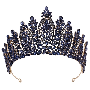 Close-up of golden alloy bridal crown featuring deep blue rhinestones and floral patterns