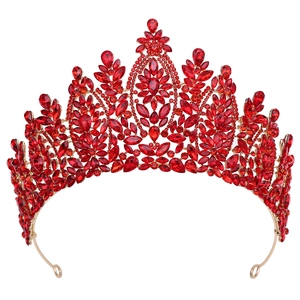 Detailed macro view of baroque bridal crown with ruby red crystals and golden alloy base