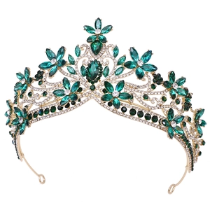 Macro shot of gold floral bridal crown with deep green crystals and sparkling diamonds