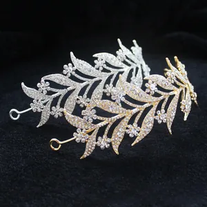 Detail of silver and gold bridal crowns with hollow leaf patterns and clear rhinestones