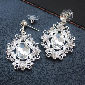 Silver oval crystal drop earrings with large rhinestone center and elegant vine frame