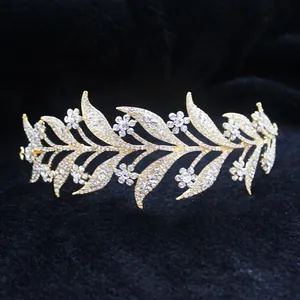 Detail of golden bridal crown with white rhinestones in leaf and flower design