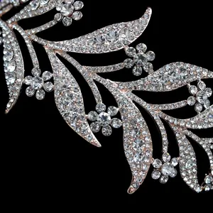 Detailed macro view of rose gold leaf tiara with sparkling white rhinestones and floral vine