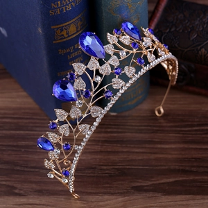 Detail of baroque bridal crown with blue teardrop crystals and gold leaf pattern