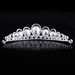 Detail of silver bridal tiara showing intricate arched hollow design and brushed texture finish