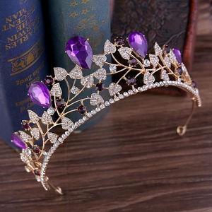 Close-up of golden leaf bridal crown with purple pear-shaped crystals and fine rhinestones