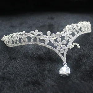Detail view of the silver flower tiara featuring a sparkling pear-shaped crystal pendant