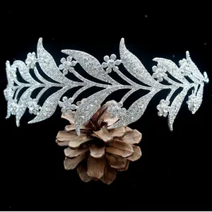 Detail of silver bridal tiara with white rhinestones in leaf and flower pattern