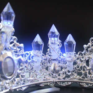 Macro detail of silver alloy bridal crown with blue LED lights and crystal pillars