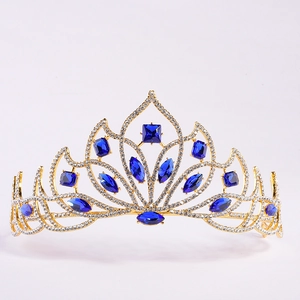 Detailed macro view of golden tiara with deep blue crystals and petal-shaped rhinestones