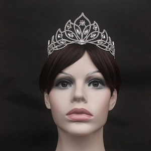 Close-up of a silver bridal tiara with sparkling crystal petals and hollow wave patterns