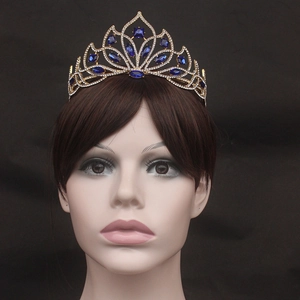 Macro detail of luxury gold bridal tiara with blue marquise crystals and rhinestones