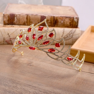 Detailed close-up of European bridal tiara with red crystals and white rhinestones