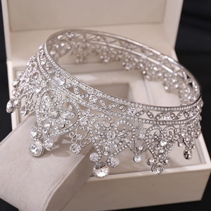 Detailed macro of a silver bridal crown with crystals and heart-shaped hollow patterns