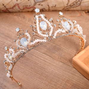 Baroque bridal crown with opals, pearls, and crystals on a vintage gold metal frame